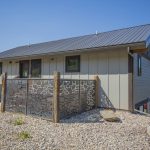 back yard with gravel and enclosed patio