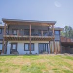 Front of Home with 2nd Story Patio and 3 sided attached carport