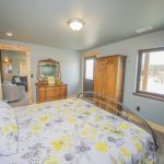 Bedroom with Yellow Floral Bedspread and warm wood furniture