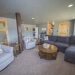 Comfy Couches in the family room with stacked washer and dryer